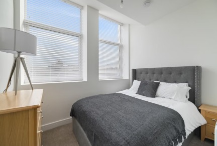 Bedroom with grey headboard