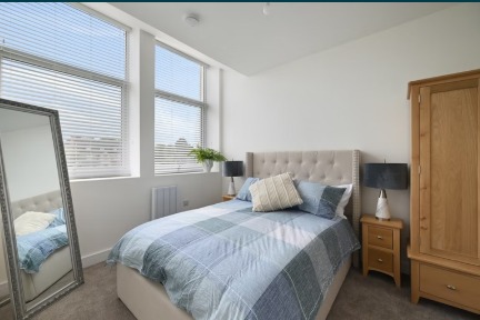 Bedroom with mirror and wardrobe