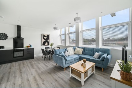 Open-plan living area with blue sofa
